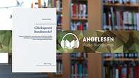 Im Vordergrund weißes Buchcover mit blauer und schwarzer Schrift.